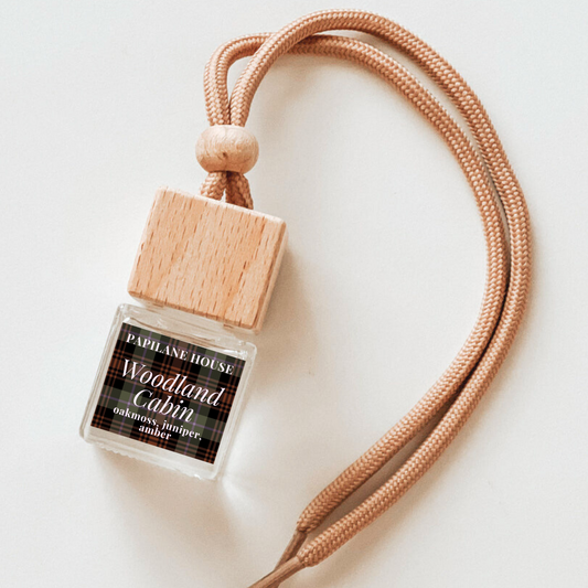 Car diffuser in scent Woodland Cabin with a plaid label and wooden cap